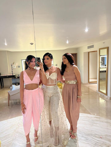 sister duo with mom ready for welcome dinner in Blush pink dhoti set, queen skirant set & Kara jumpsuit