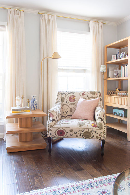 Classic living room design in Atlanta with Oka Tarma embroidered armchair, brass coffee tables, silk pillow, and floral rug on design blog The Francis Files by Kevin Francis O'Gara