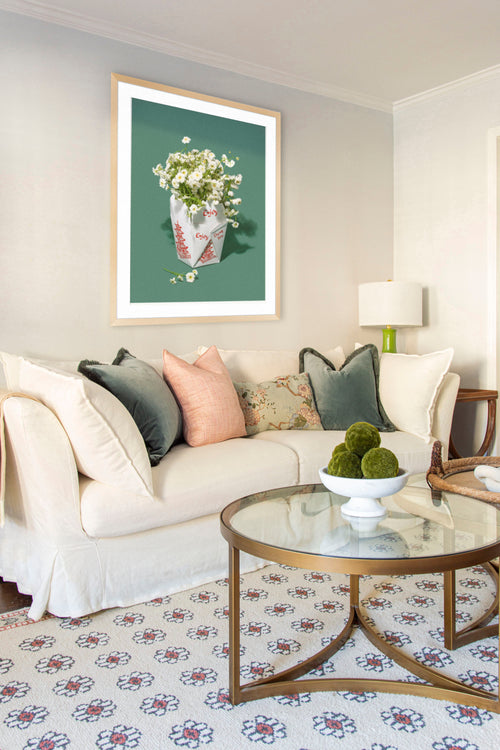 Classic living room design in Atlanta with Oka Avitus linen cloud sofa, brass coffee tables, velvet pillows, and floral rug on design blog The Francis Files by Kevin Francis O'Gara