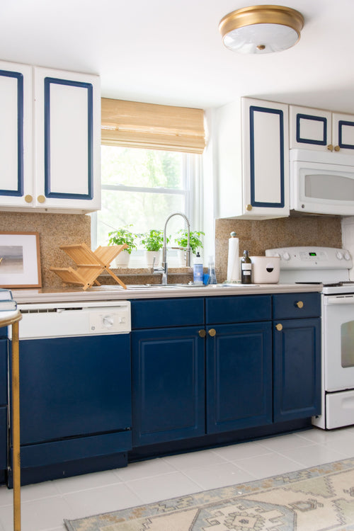 Navy blue kitchen makeover with Samsung Bespoke glass refrigerator review, Behr Nocturne cabinets, Repose Gray painted tile floor, cabinets with painted border
