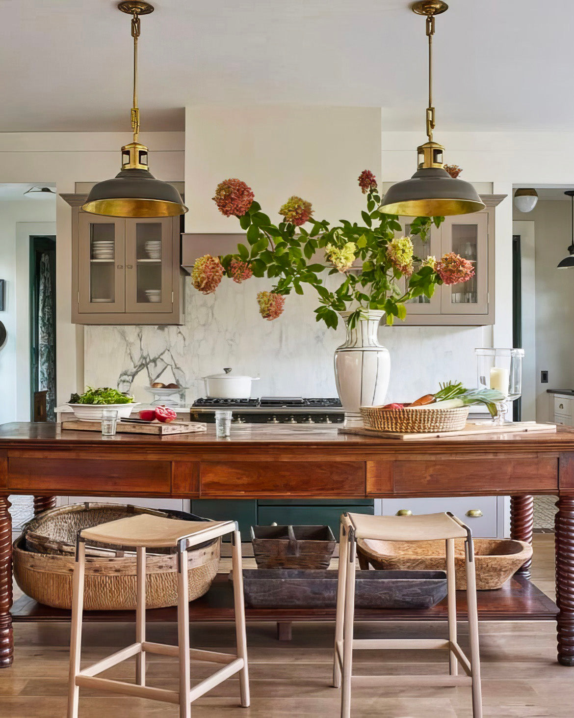 Antique wooden counter kitchen island in a warm traditional kitchen design with taupe cabinets and marble slab backplash on The Francis Files design blog