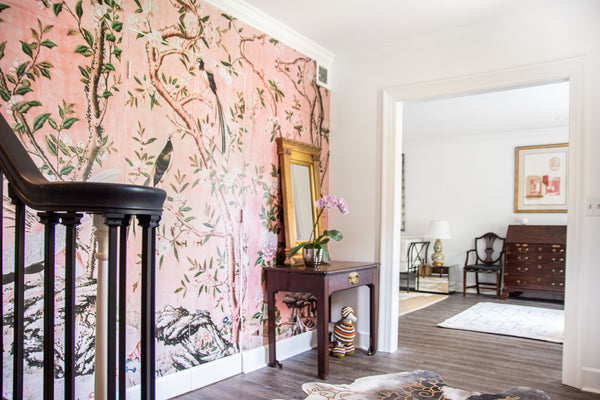 Pink chinoiserie wallpaper covers the wall in a Hollywood Regency style entryway design in Buckhead Atlanta