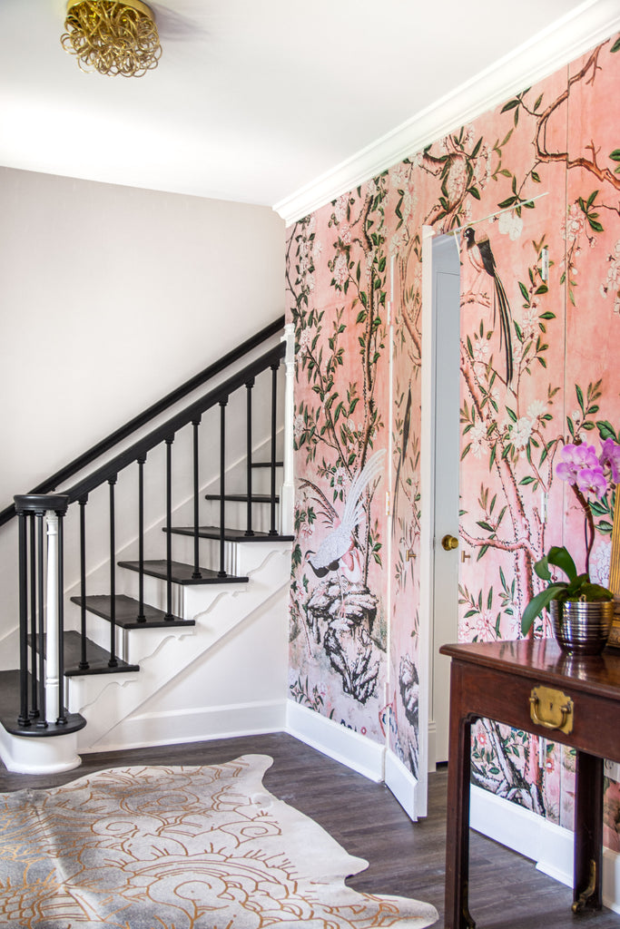 Hollywood Regency entry design with pink chinoiserie wallpaper