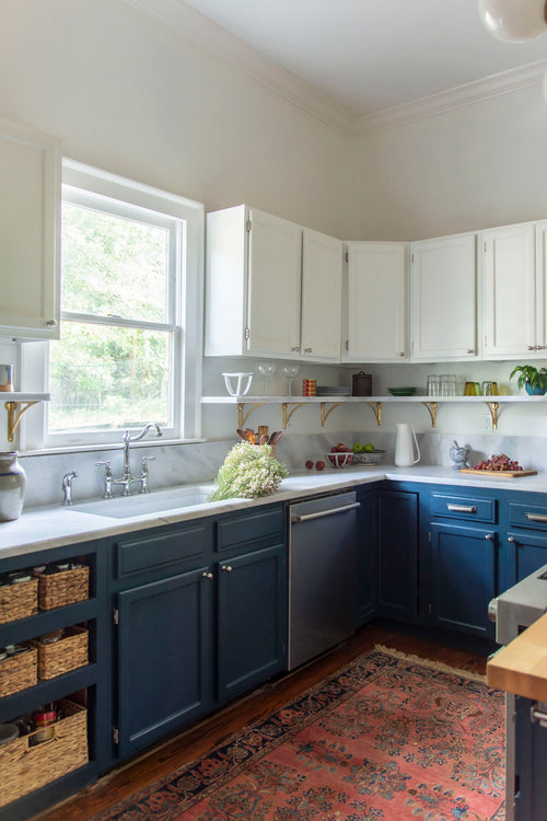 Historic kitchen renovation with navy blue cabinets, Georgia marble countertops, fireclay sink, bridge sink faucet, mixed metals, brass and nickel, and Alabaster paint by Kevin Francis Design