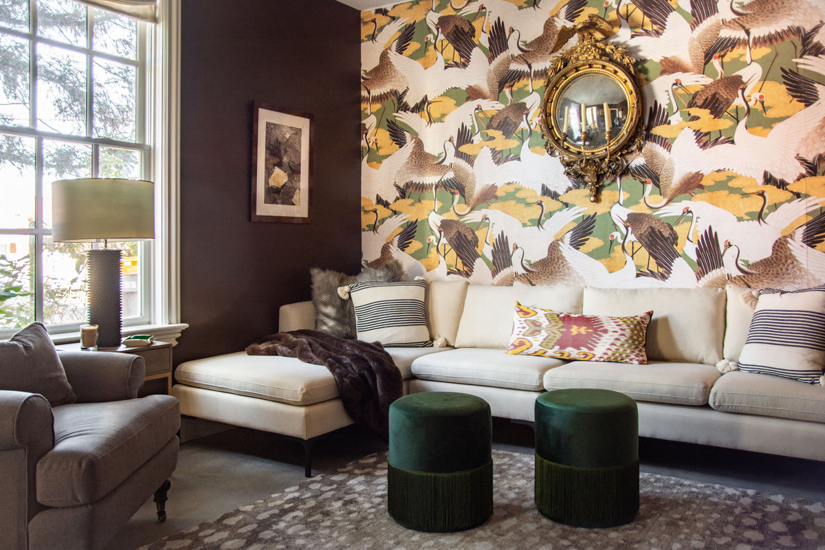 Dark brown paint in cozy living room media room design by Kevin Francis O'Gara, using Behr Dark Truffle paint, antelope rug, and cranes wallpaper