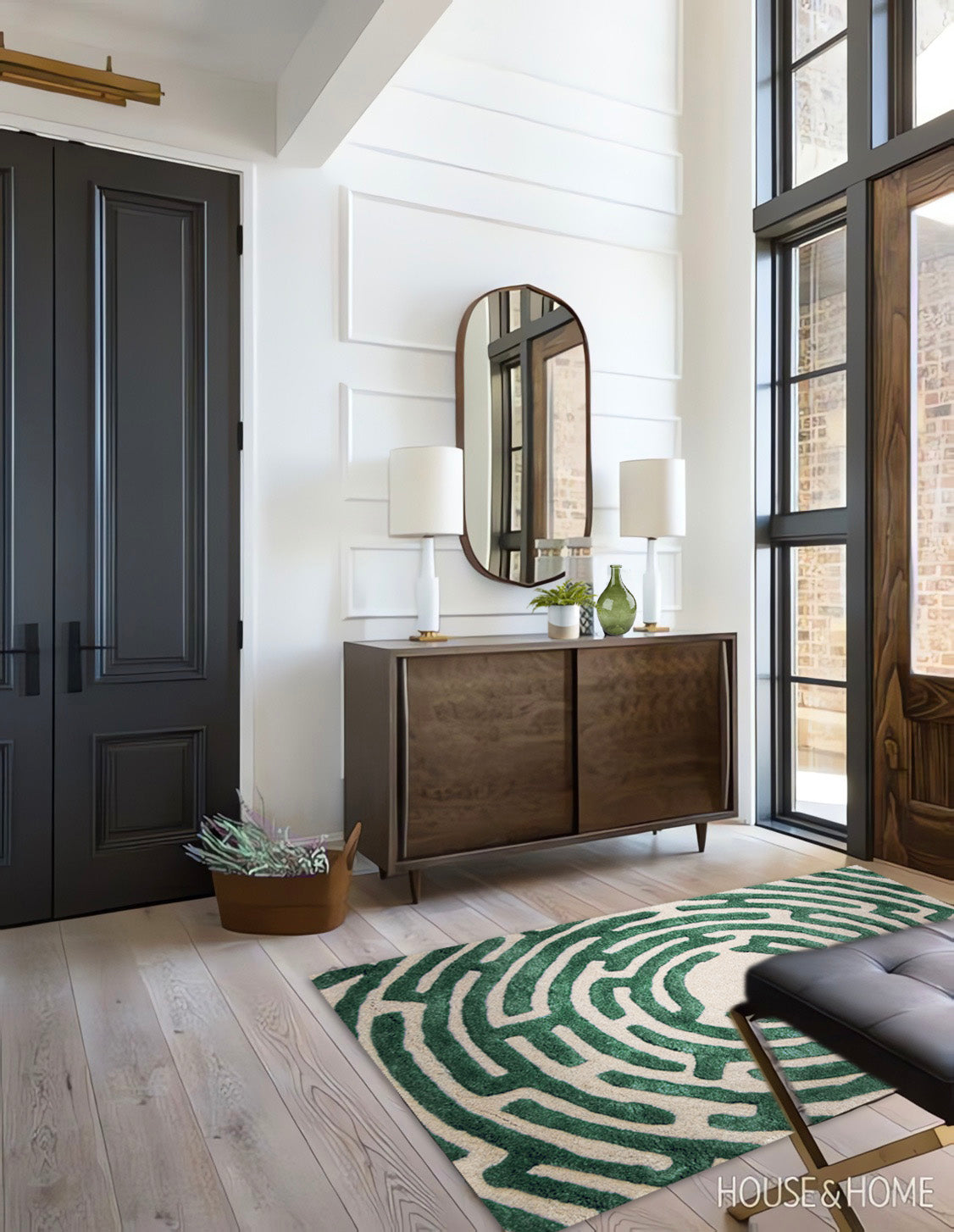 Modern rustic mountain house entry design with green circular maze rug by Kevin Francis, hand-tufted wool luxury area rugs