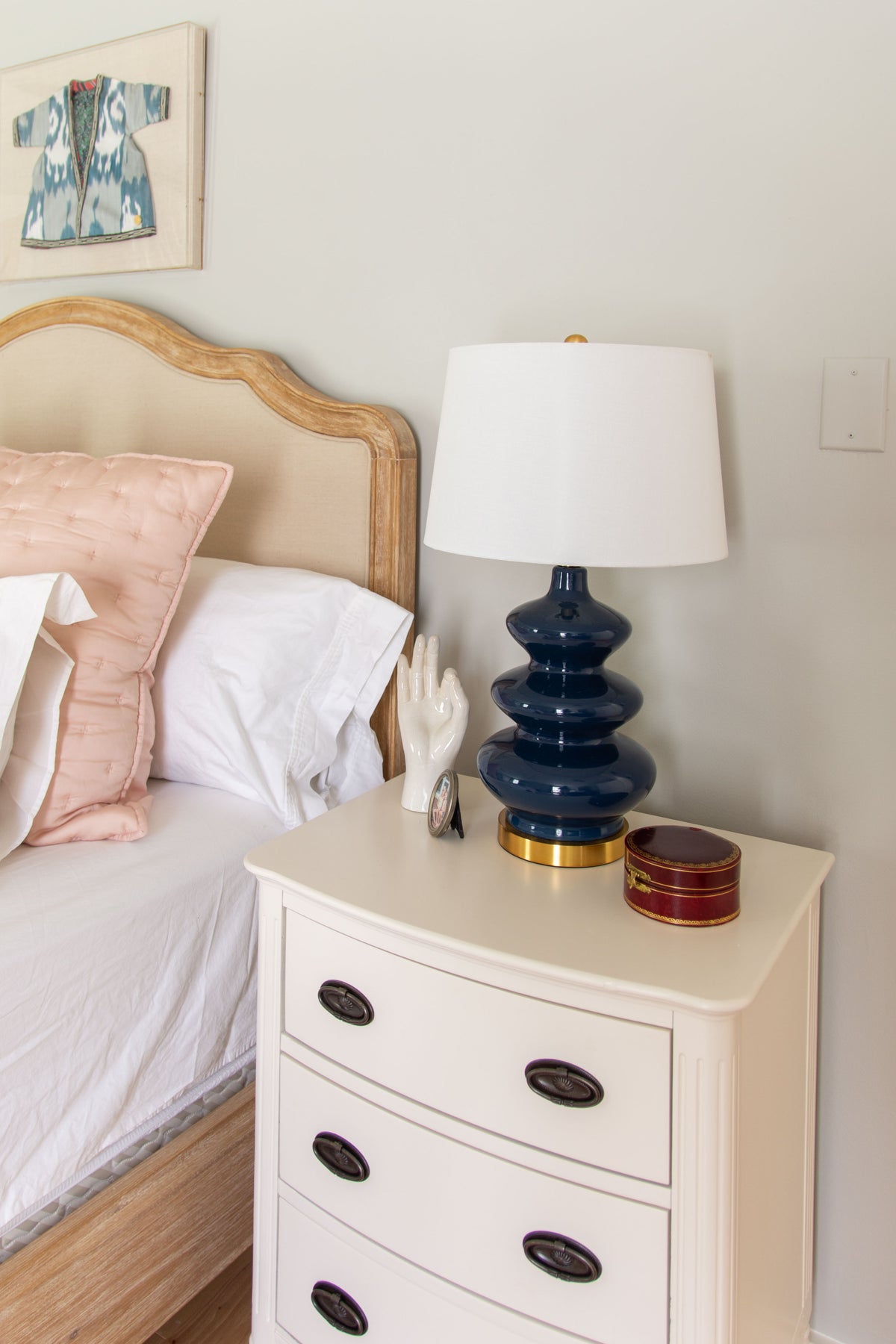 Primary bedroom design with Behr Gratifying Gray wall paint, pink bedding, and vintage rug by Atlanta designer Kevin Francis O'Gara