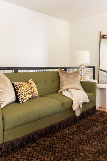 Media room loft design by Atlanta interior designer Kevin Francis O'Gara with the Queer Eye Kerswell futon, brown shag rug, and custom painting