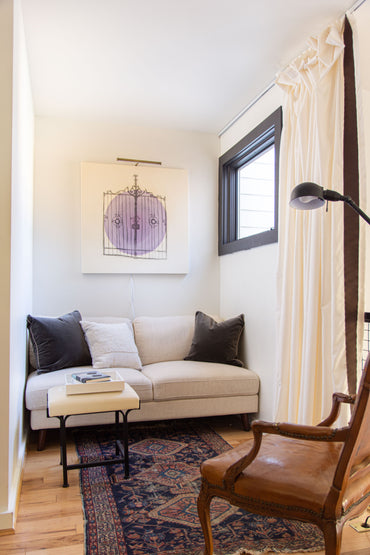 Media room loft design by Atlanta interior designer Kevin Francis O'Gara with the Queer Eye Kerswell futon, vintage rug, and custom painting