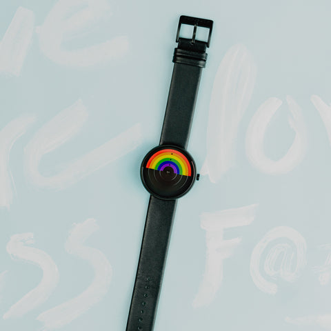Pride watch on light blue background (laying flat vertically)