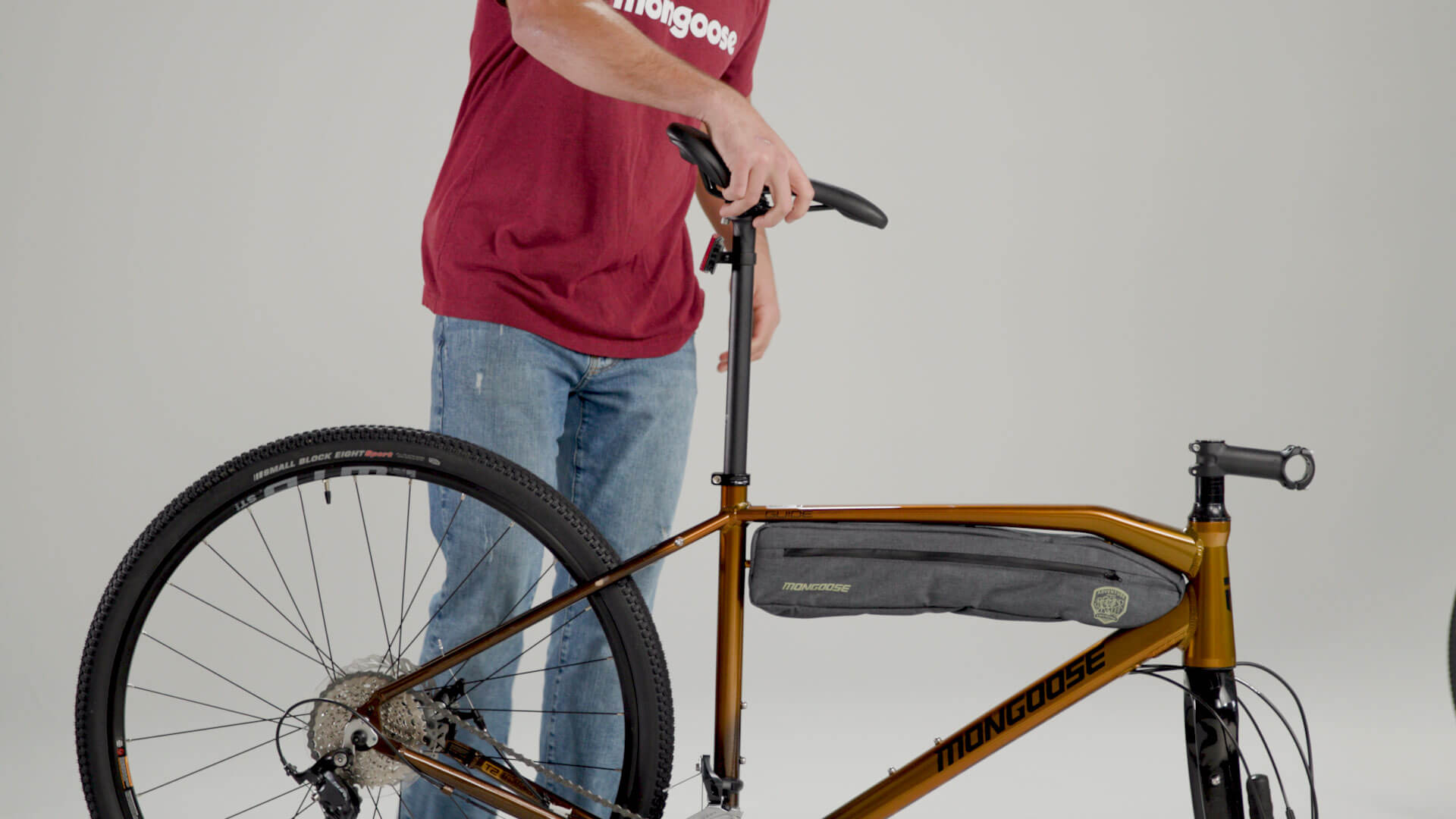 A person installing a seatpost on a Mongoose Guide Sport gravel bike.