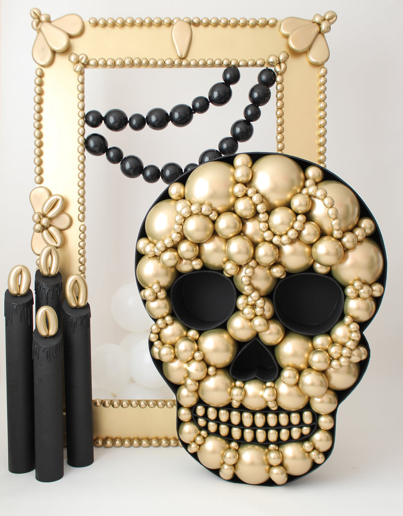 Balloon Mosaic Skull in Black and gold in front of a gold DIY Oversized Frame