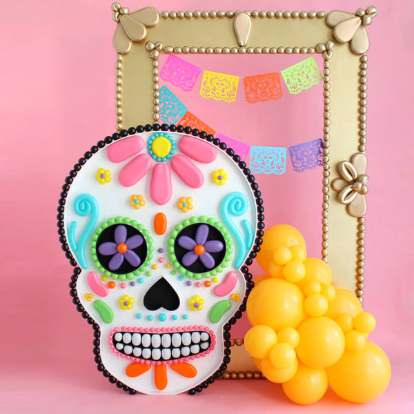 Sugar Skull Balloon Mosaic in front of a gold oversized frame made out of foamboard.