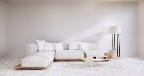 Trendy living room with white sofa and white tile flooring