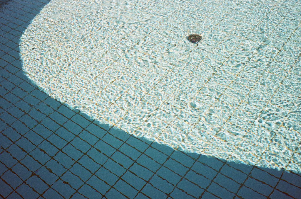 Rectangular White Pool Tiles Underneath Water In Sunlight