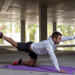 Bird Dog exercise by man strengthening his core for lower back pain