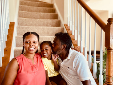 Monique Farook poses with her husband and young child