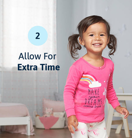 smiling girl in play room wearing rainbow t-shirt with overlayed text "allow for extra time"