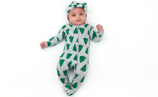 This sweet baby girl is rocking a festive look with her green Christmas tree onesie and a cute headband to match.