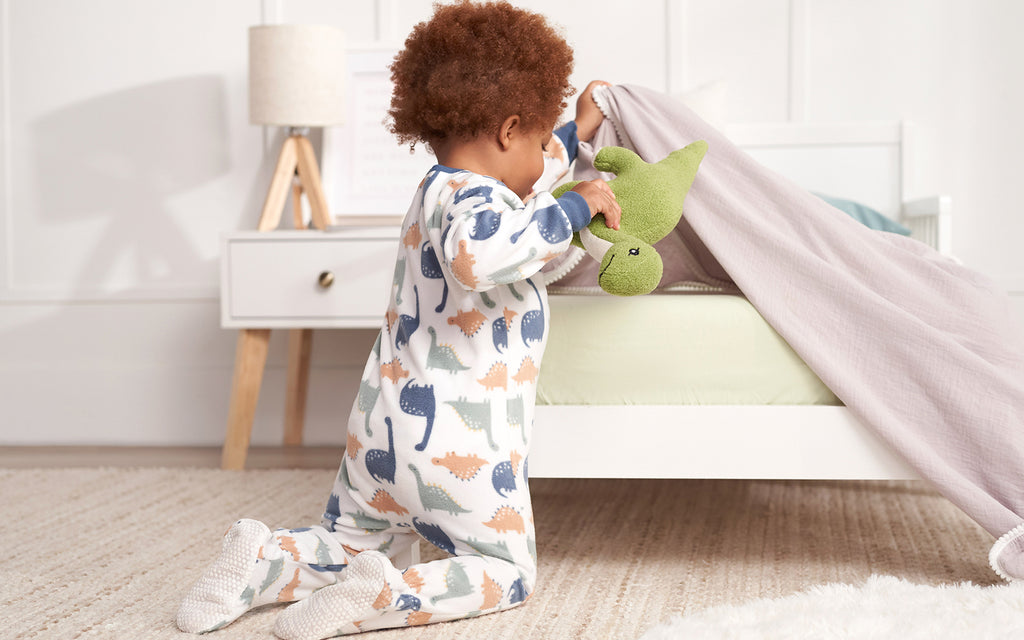 baby boy wearing dinosaur clothes while playing