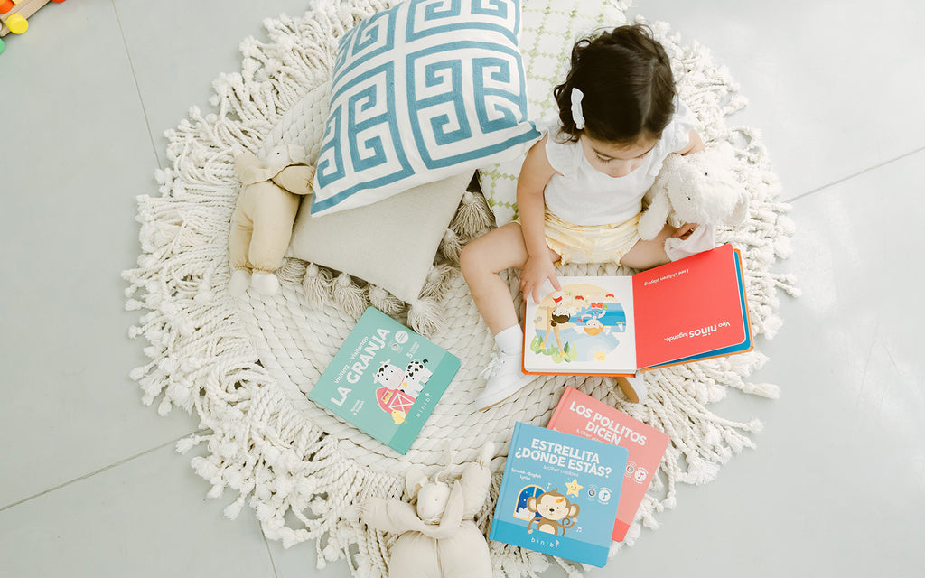 child sits on rug surrounded by books while reading