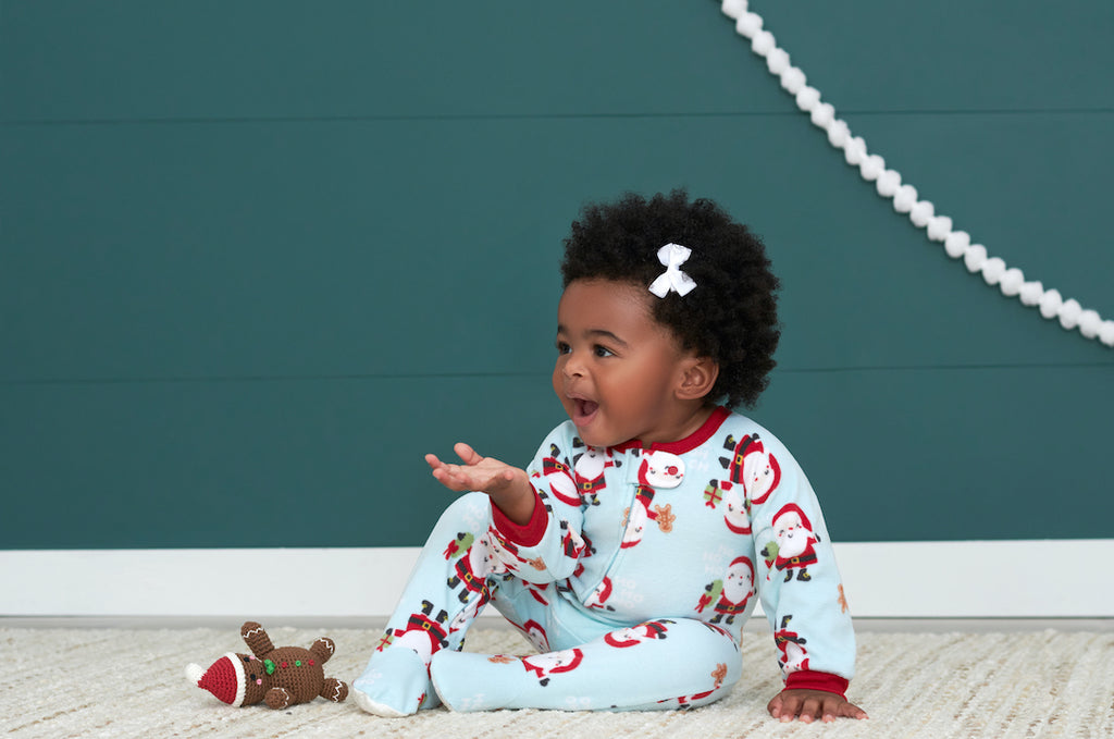 Baby Girl Wearing Footed Fleese Holiday Santa Sleepwear Pajamas