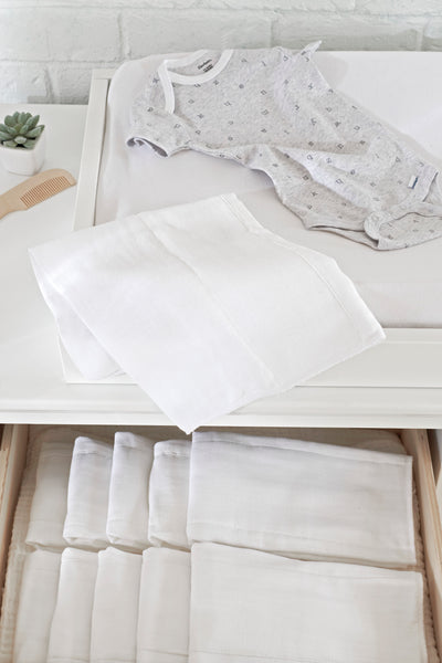 White cloth diapers organized in dresser drawer