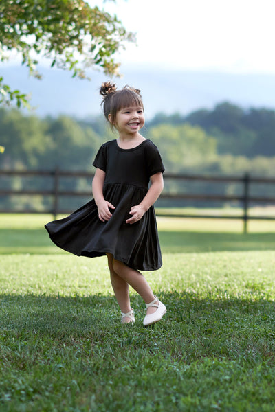 Girl outside wearing black twirl dress
