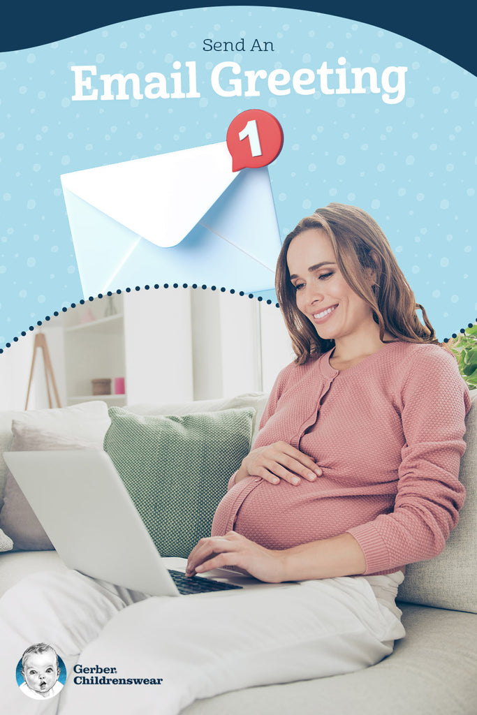 Photo of a pregnant woman sitting on a couch typing on her computer laptop.