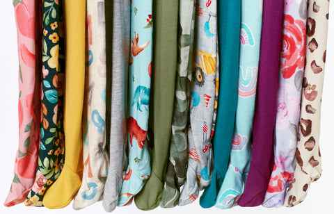 Row of footed pajamas in various colors and prints