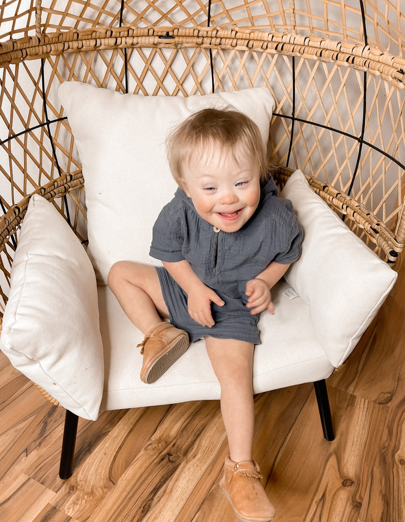 Aspen sitting on a chair smiling