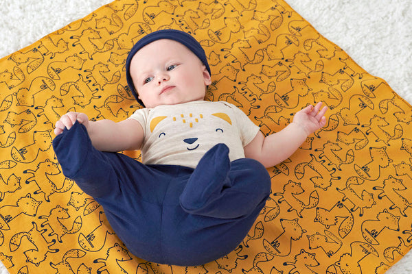 Baby Boy Lying Down on Flannel Blanket as a DIY Changing Pad for On the Go Diaper Changes