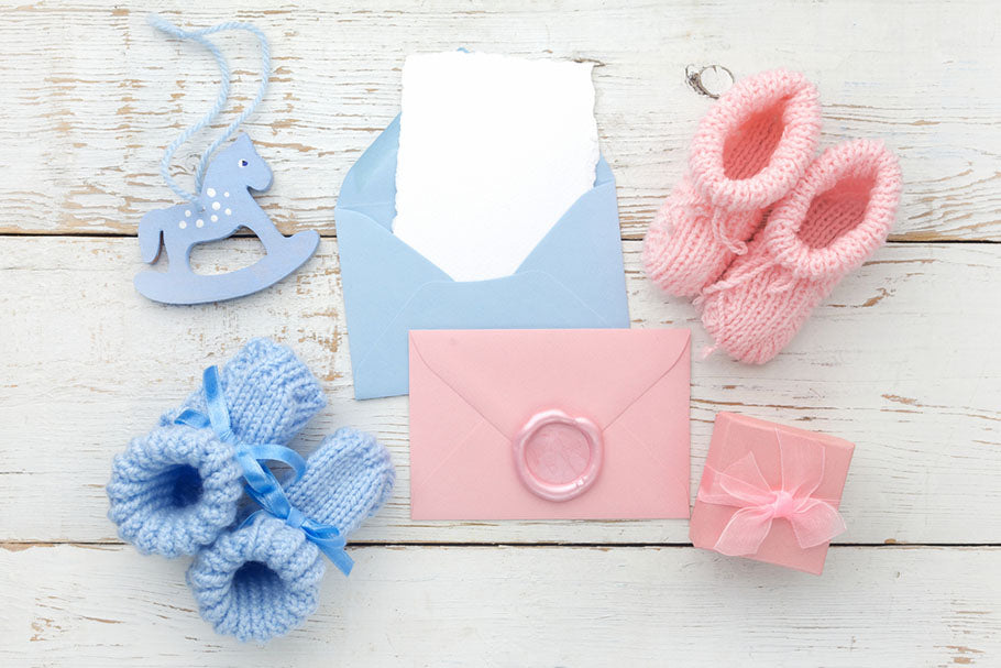 Set of baby girl and boy booties and greeting card