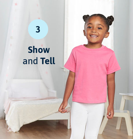 smiling toddler girl in pink and white outfit with text overlayed "show and tell"