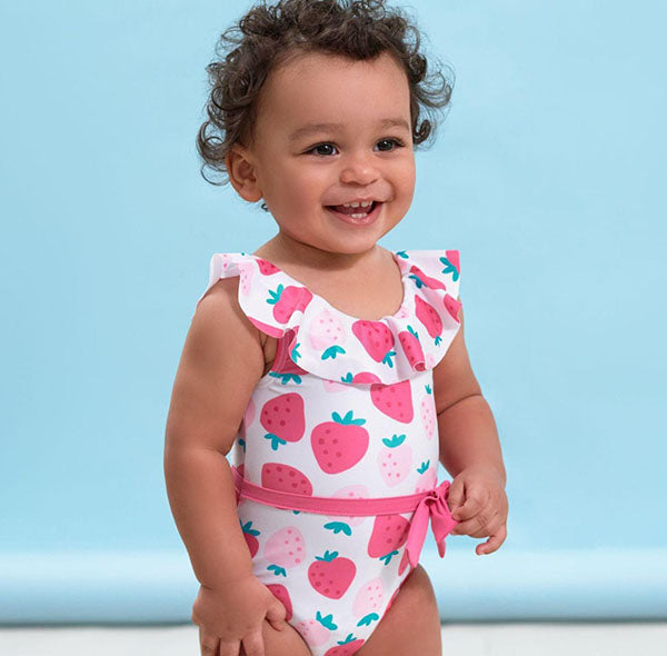 baby girl in strawberry print swimsuit
