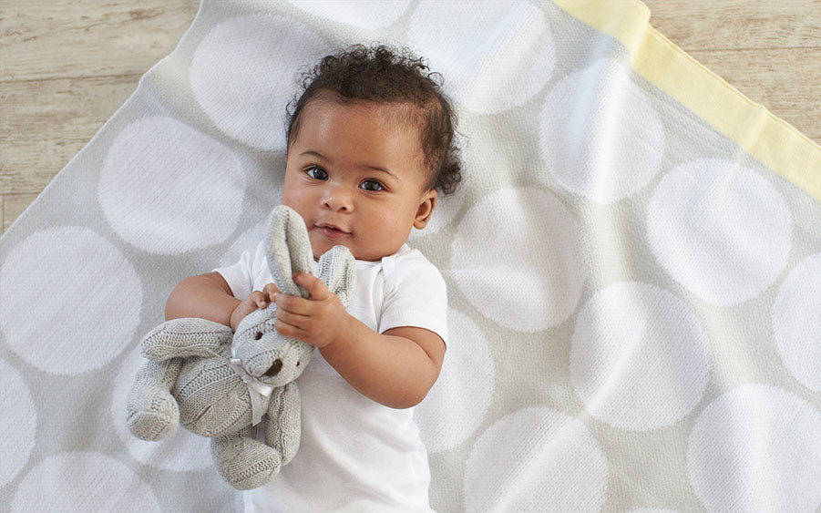 baby holding stuffed bunny