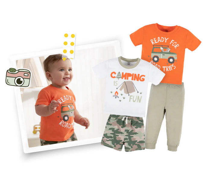 smiling baby boy wearing orange t-shirt that reads "ready for road trip" while wearing camo pants