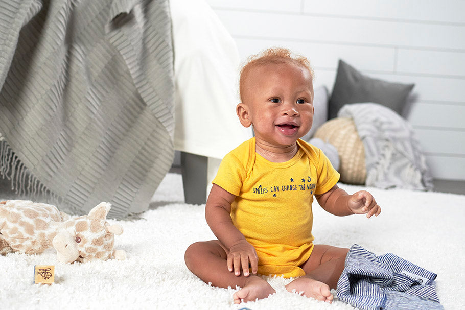 cute baby in yellow onesies® brand bodysuit