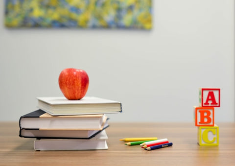 School supplies and a shiny red apple, ready for a new academic year. Get equipped for success!