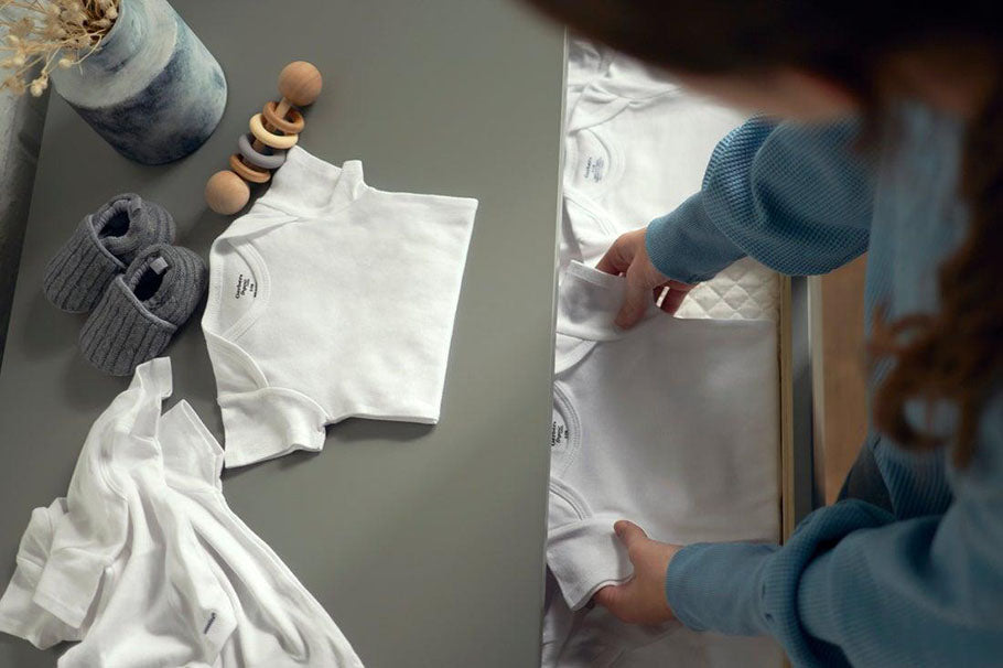 folding white onesie in drawer