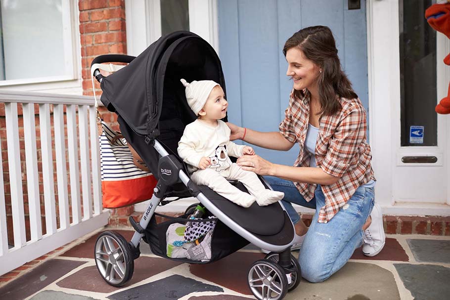 mom putting baby in stroller