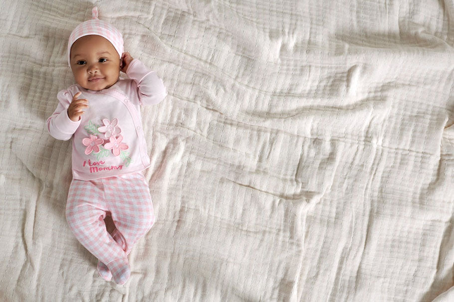 newborn baby on bed