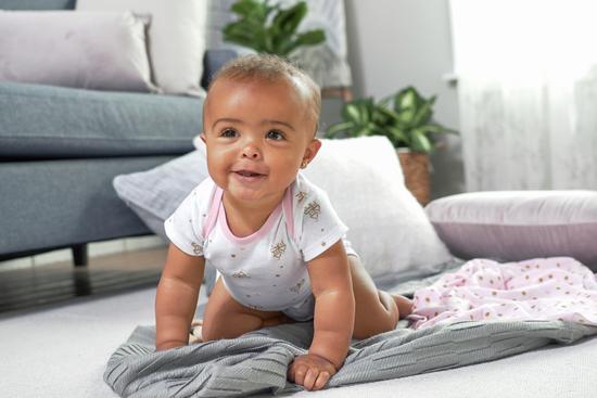 newborn in white bodysuit