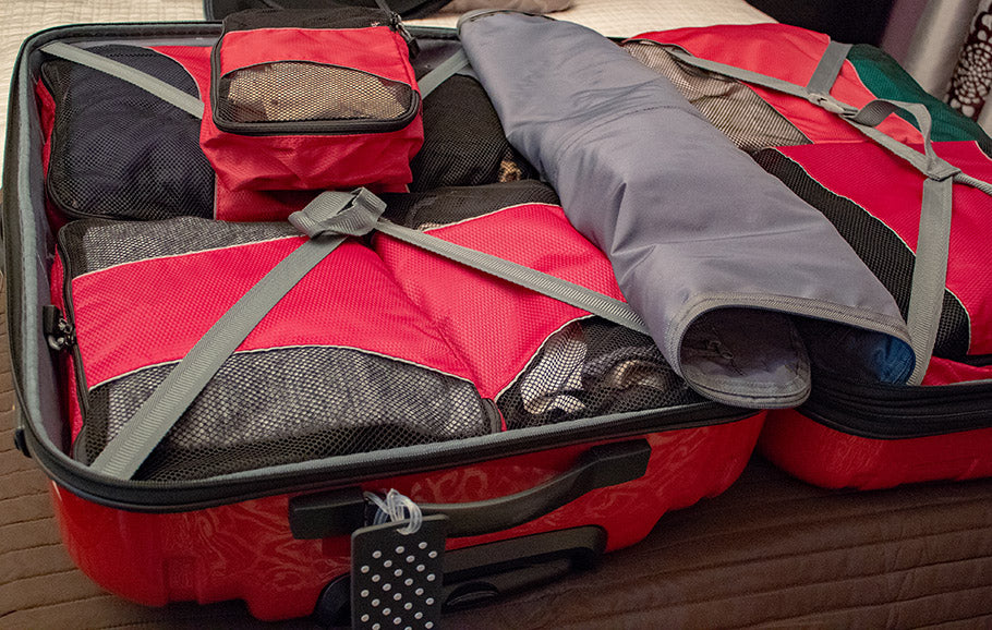 An open suitcase with packing organizers. Packing for vacation.