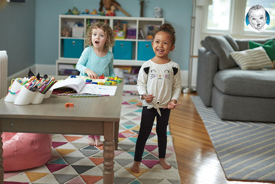 pair of toddlers play with toys