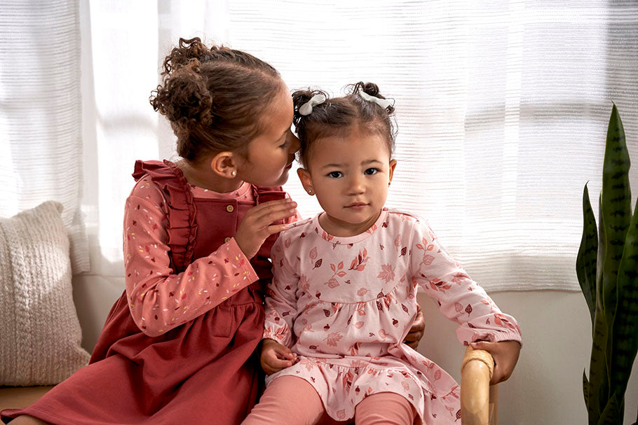 sisters sit in chair