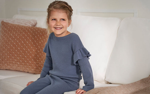Smiling blonde child in soft and fuzzy blue outfit