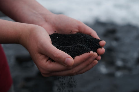 hands holding fresh black dirt