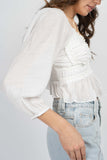 This ruffle blouse features quarter bubble sleeves, sweetheart neckline, ruffle details, and tiered details.