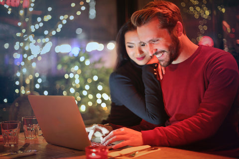 couple looking at laptop booking wedding suppliers